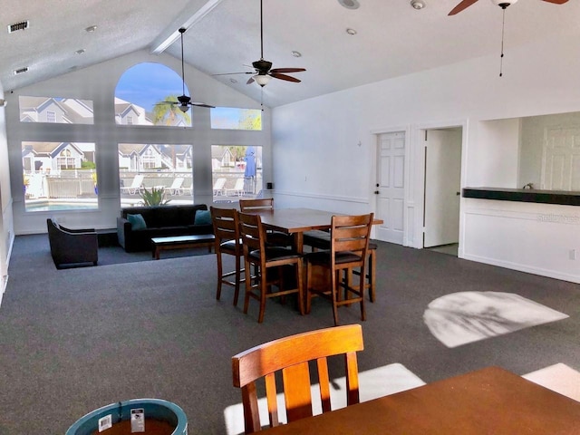 dining area with high vaulted ceiling, carpet flooring, visible vents, a ceiling fan, and beam ceiling