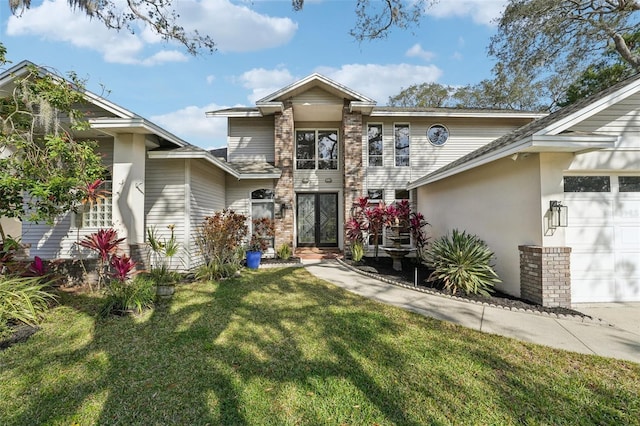 view of front of home with a garage and a front lawn