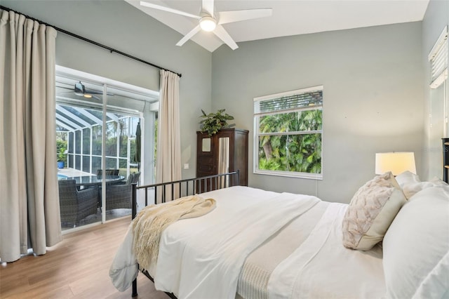 bedroom featuring ceiling fan, lofted ceiling, access to exterior, and light hardwood / wood-style floors