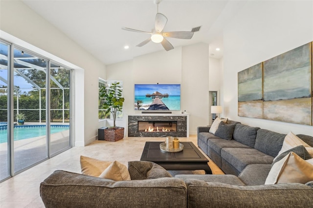 living area featuring baseboards, ceiling fan, a fireplace, high vaulted ceiling, and recessed lighting