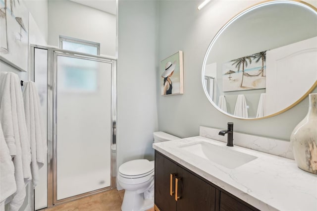 full bathroom featuring toilet, a shower stall, and vanity