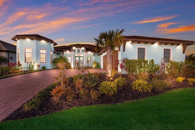 mediterranean / spanish-style home featuring a lawn