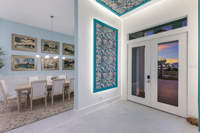 dining area featuring french doors and an inviting chandelier