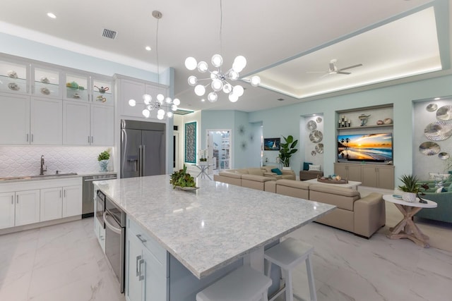 kitchen featuring white cabinetry, sink, and built in refrigerator