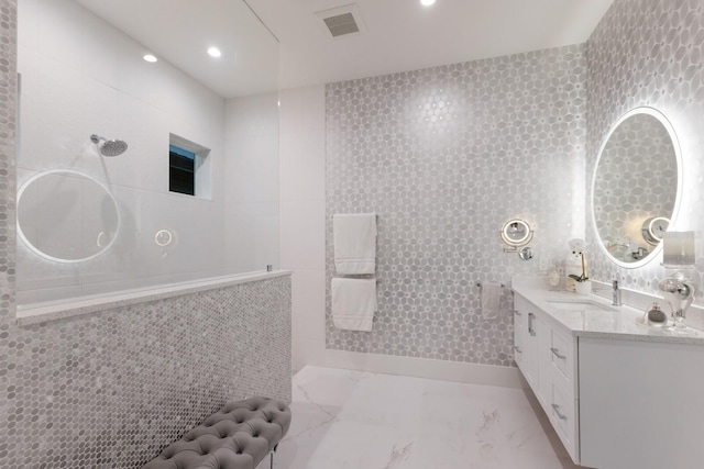 bathroom with vanity and tile walls