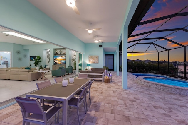 view of patio / terrace featuring an outdoor hangout area, a jacuzzi, and a lanai