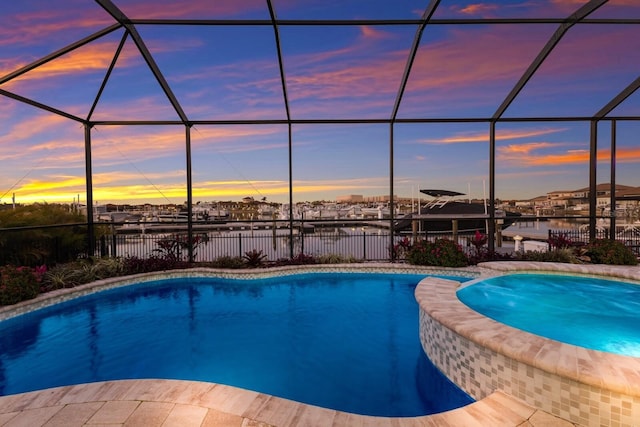 pool at dusk featuring a water view and glass enclosure