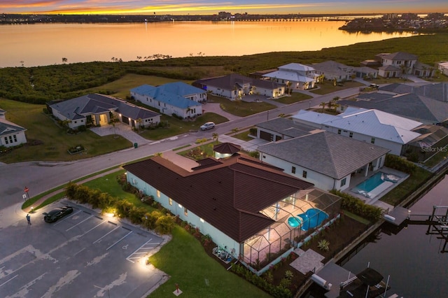 aerial view at dusk with a water view