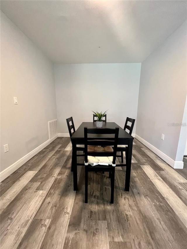 dining space featuring dark wood-type flooring