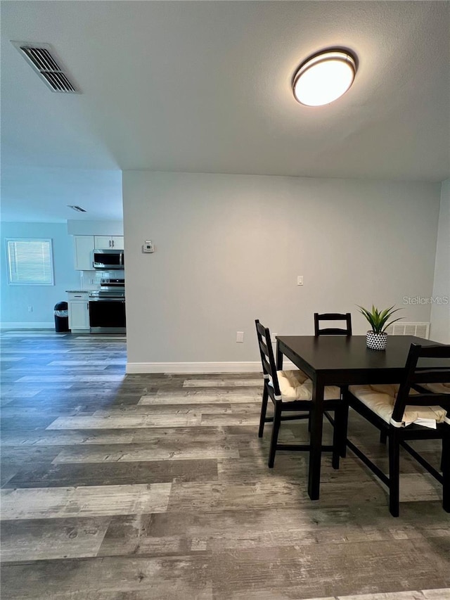 dining area featuring wood-type flooring