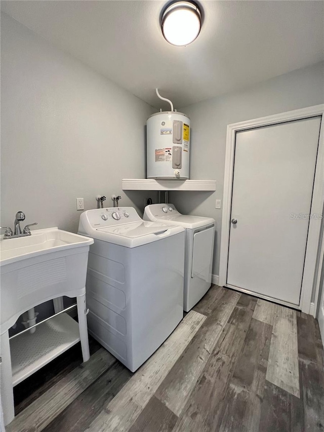 washroom featuring independent washer and dryer, dark hardwood / wood-style floors, and water heater