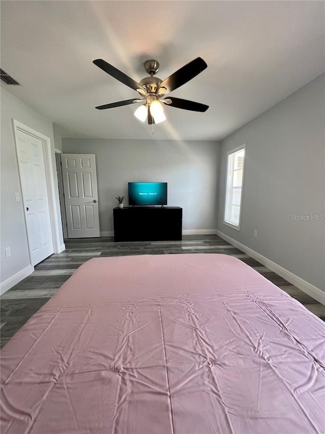 unfurnished bedroom featuring dark hardwood / wood-style floors and ceiling fan