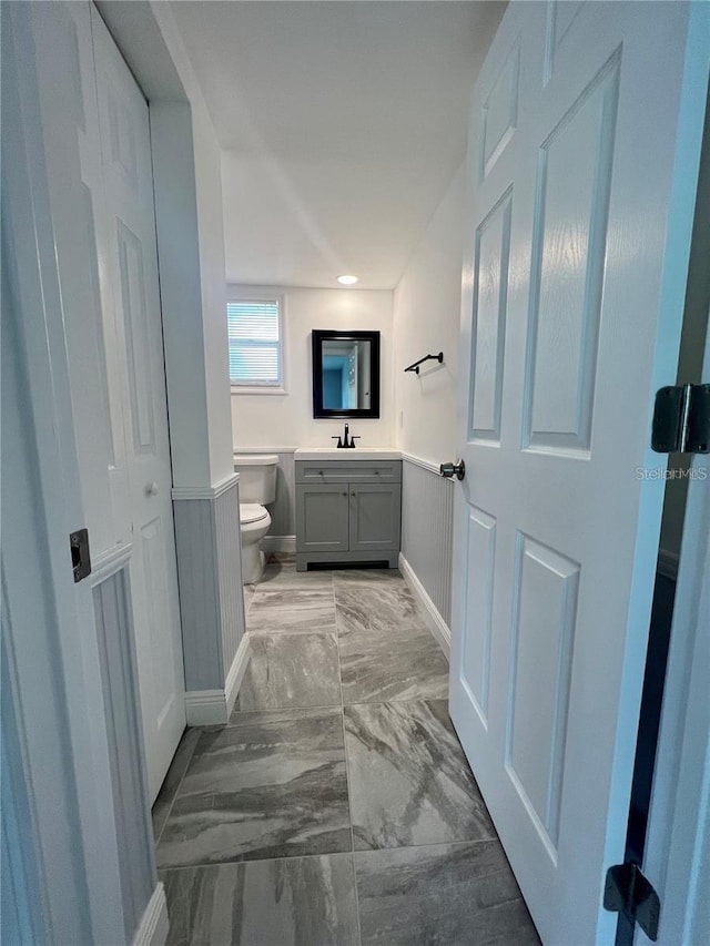 bathroom featuring vanity and toilet