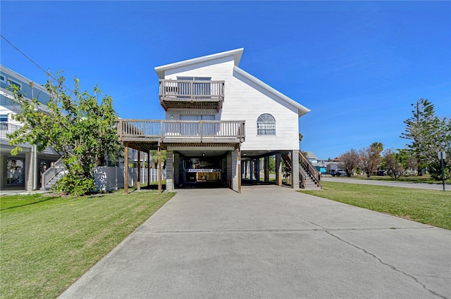 coastal home featuring a front lawn, a carport, and a balcony