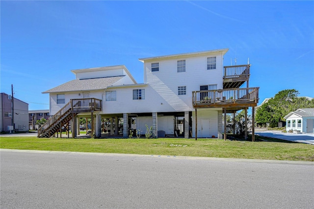 exterior space featuring a wooden deck and a lawn