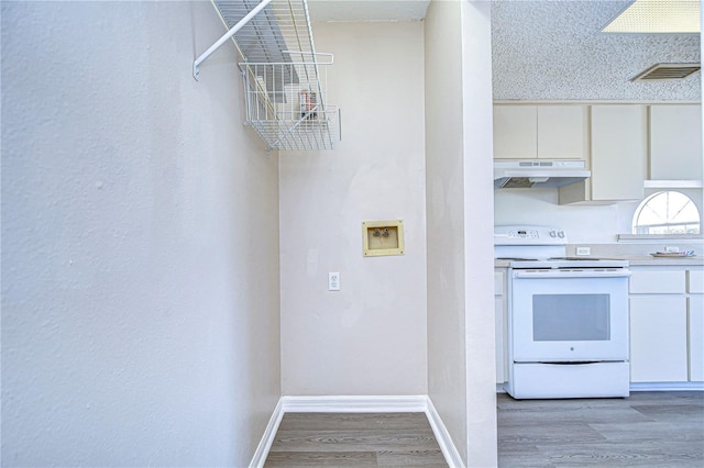 kitchen with hardwood / wood-style floors, white cabinetry, white electric range oven, and a textured ceiling