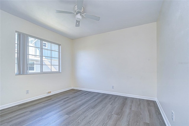 spare room with hardwood / wood-style flooring and ceiling fan