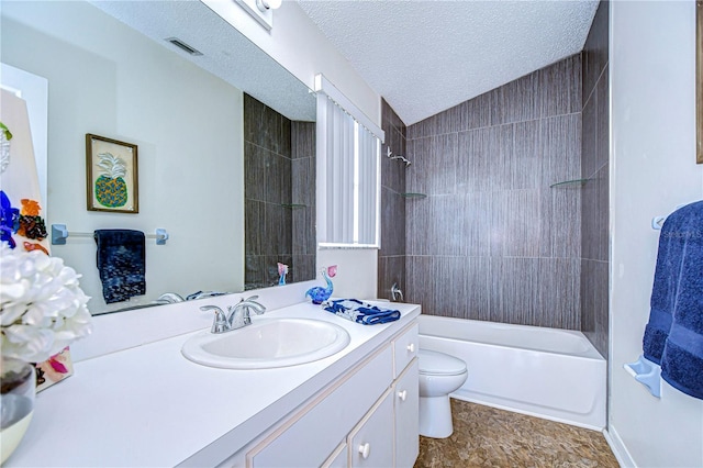 full bathroom with lofted ceiling, tiled shower / bath combo, vanity, a textured ceiling, and toilet