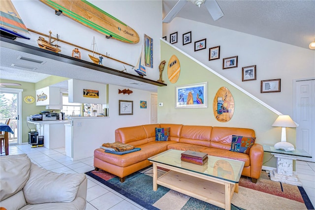 tiled living room with lofted ceiling and a textured ceiling