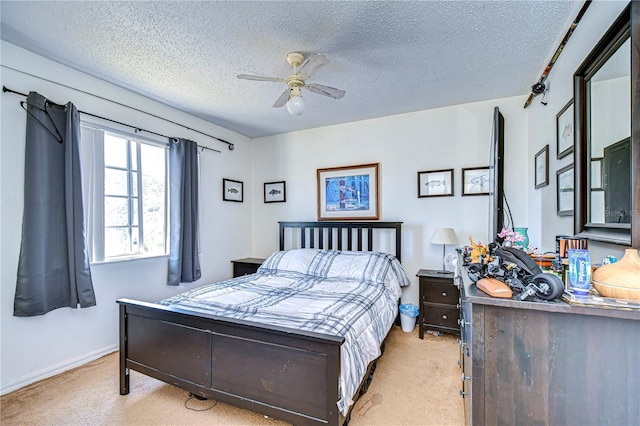 bedroom featuring ceiling fan, light carpet, and a textured ceiling