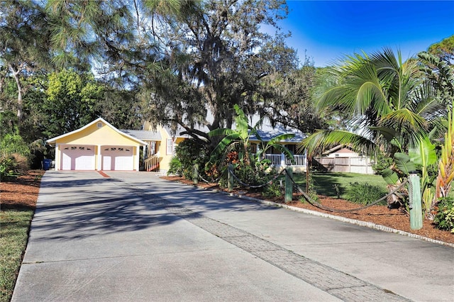 view of front of house featuring a garage and a front lawn