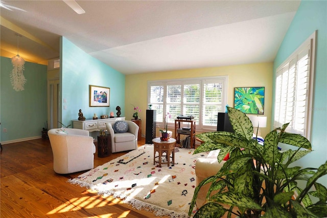 living room featuring hardwood / wood-style flooring and vaulted ceiling