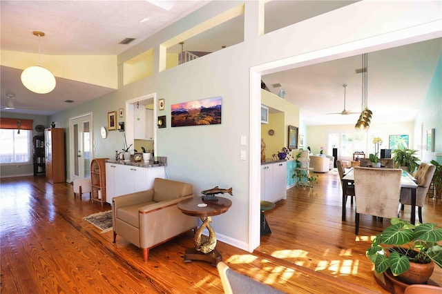 hall with lofted ceiling and hardwood / wood-style floors