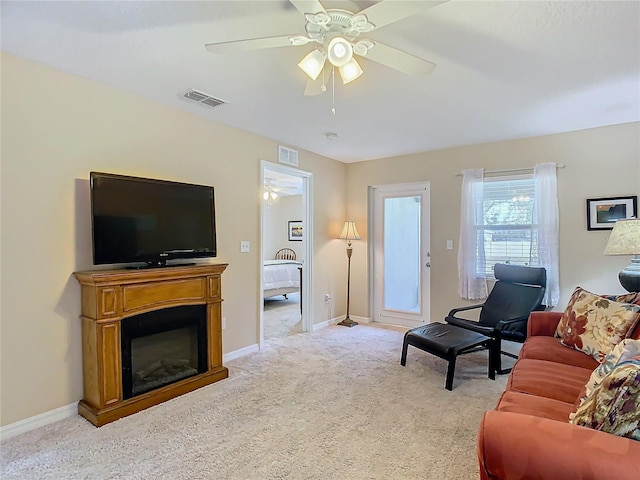 living room with ceiling fan and light colored carpet