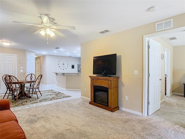 carpeted living room featuring ceiling fan