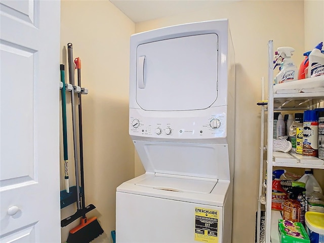 clothes washing area with stacked washer / dryer