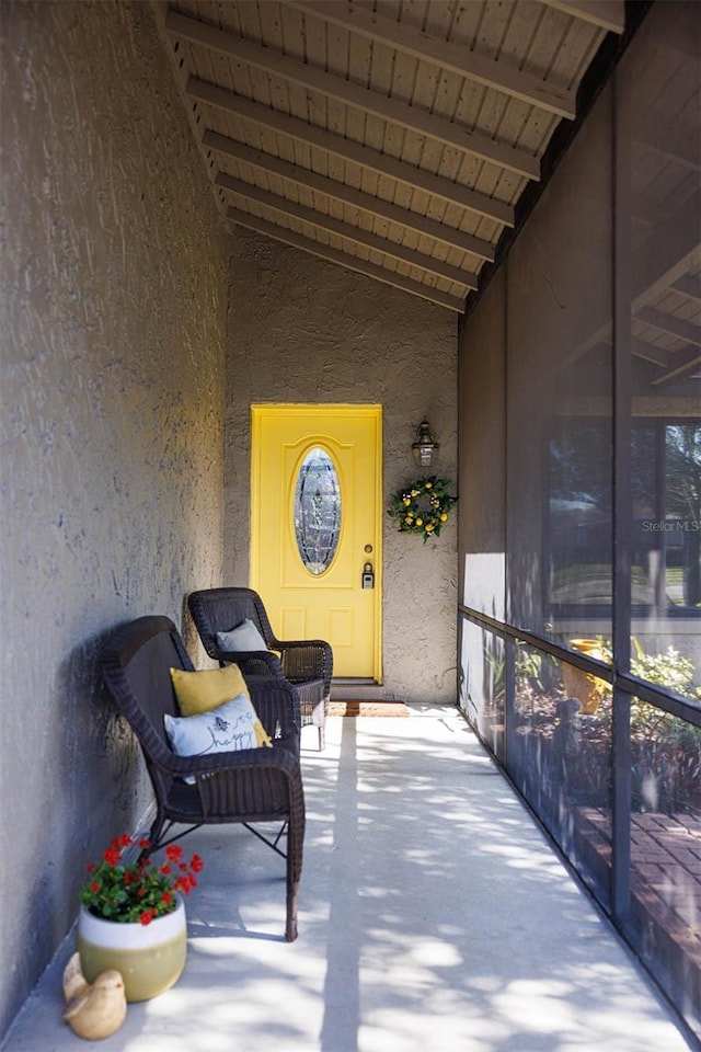 doorway to property featuring stucco siding