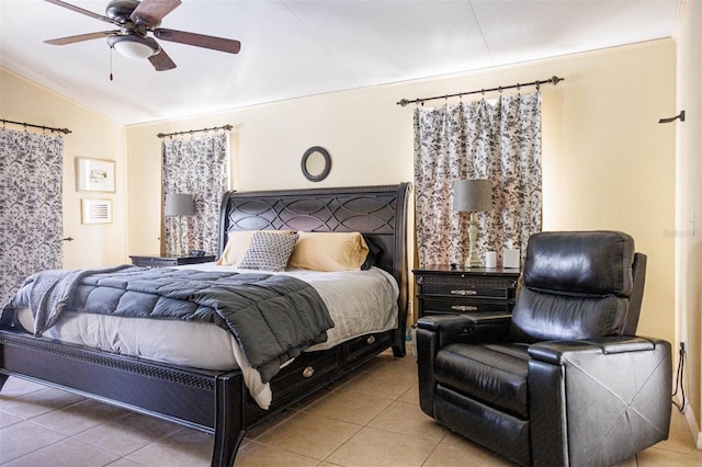 tiled bedroom featuring lofted ceiling and ceiling fan