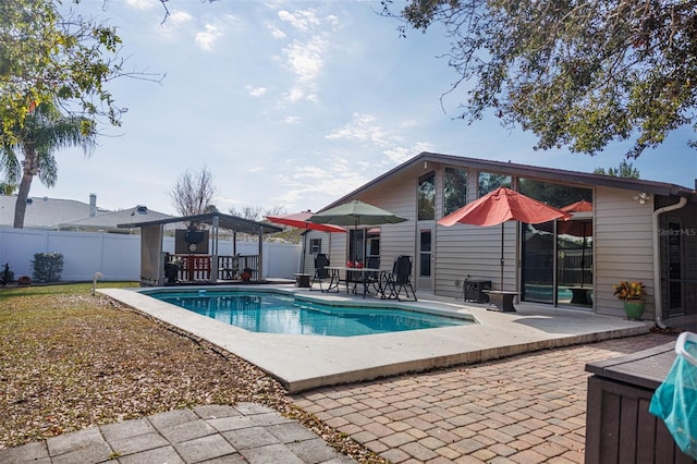 view of swimming pool with a patio area, fence, and a fenced in pool