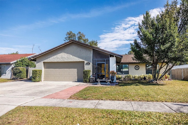 mid-century home featuring a garage, fence, a front lawn, and stucco siding