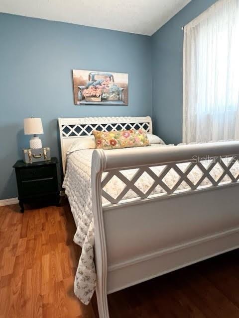 bedroom featuring wood finished floors