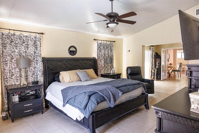 tiled bedroom with a ceiling fan and vaulted ceiling