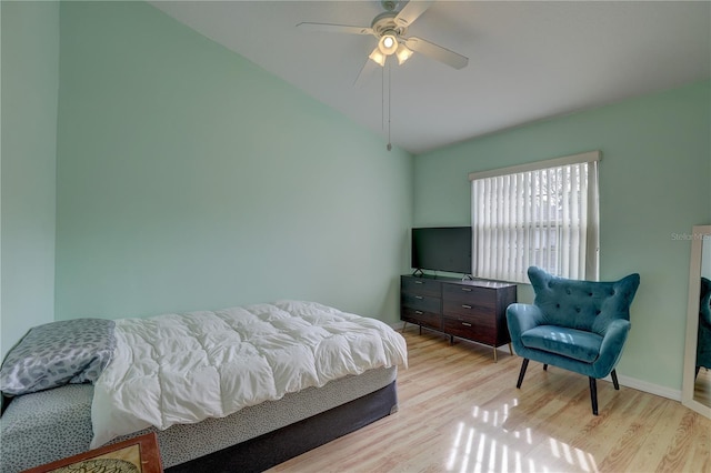 bedroom with ceiling fan, lofted ceiling, and light hardwood / wood-style flooring