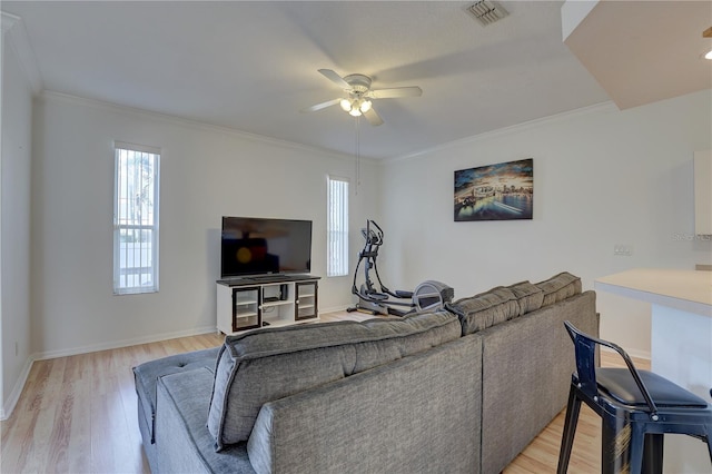 living room featuring crown molding, light hardwood / wood-style floors, and ceiling fan