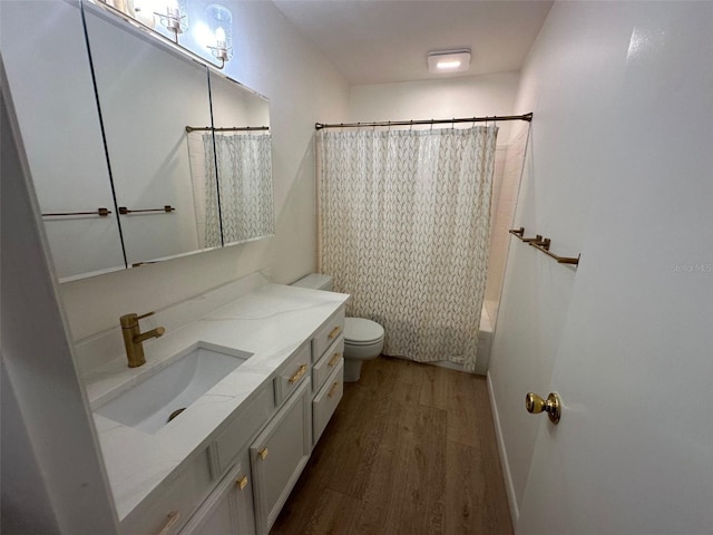 full bathroom featuring wood-type flooring, toilet, shower / bath combo with shower curtain, and vanity