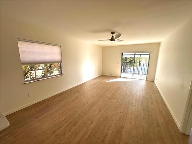 spare room with ceiling fan and light wood-type flooring