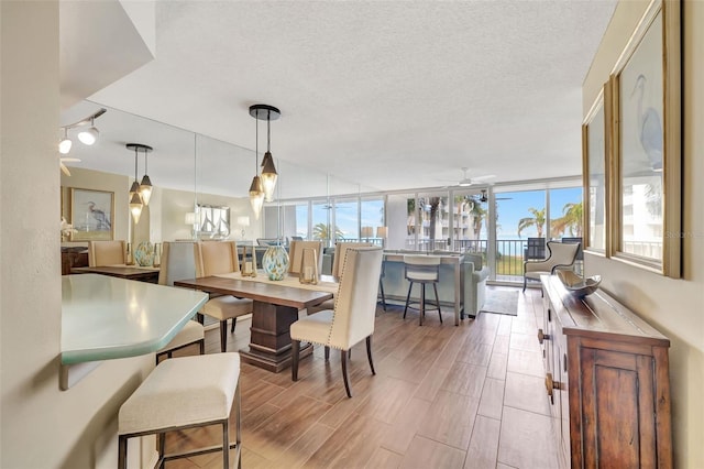 dining room with ceiling fan and a textured ceiling