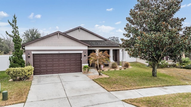 view of front of home with a garage and a front lawn