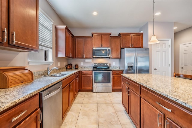 kitchen featuring sink, decorative light fixtures, light tile patterned floors, stainless steel appliances, and light stone countertops