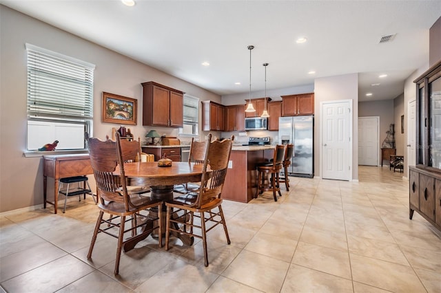 dining room featuring light tile patterned floors, baseboards, visible vents, and recessed lighting