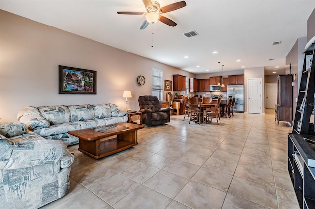 tiled living room with ceiling fan