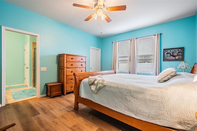 bedroom with wood finished floors, a ceiling fan, and baseboards