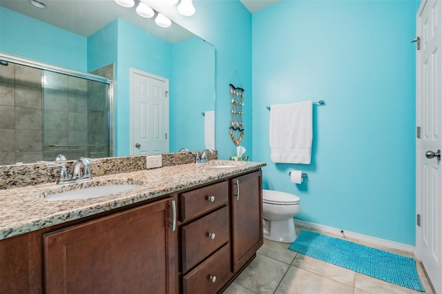 full bathroom featuring a sink, a shower stall, toilet, and tile patterned floors