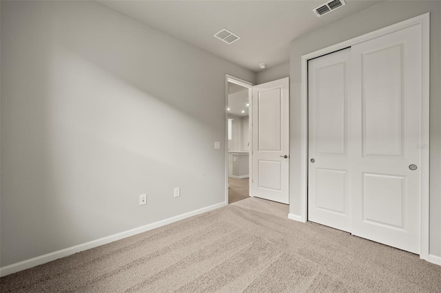 unfurnished bedroom featuring a closet and carpet