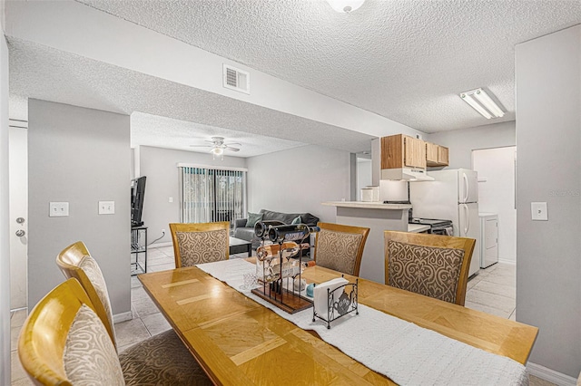 455 Alt 19 S Unit 268, Palm Harbor, FL 34683 - dining space featuring a textured ceiling, light tile patterned floors, washing machine and clothes dryer, and ceiling fan