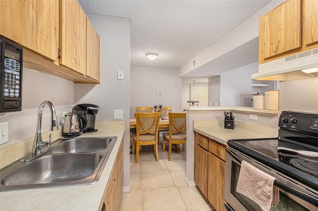 455 Alt 19 S Unit 268, Palm Harbor, FL 34683 - kitchen featuring range with electric stovetop, under cabinet range hood, a textured ceiling, light countertops, and light tile patterned floors